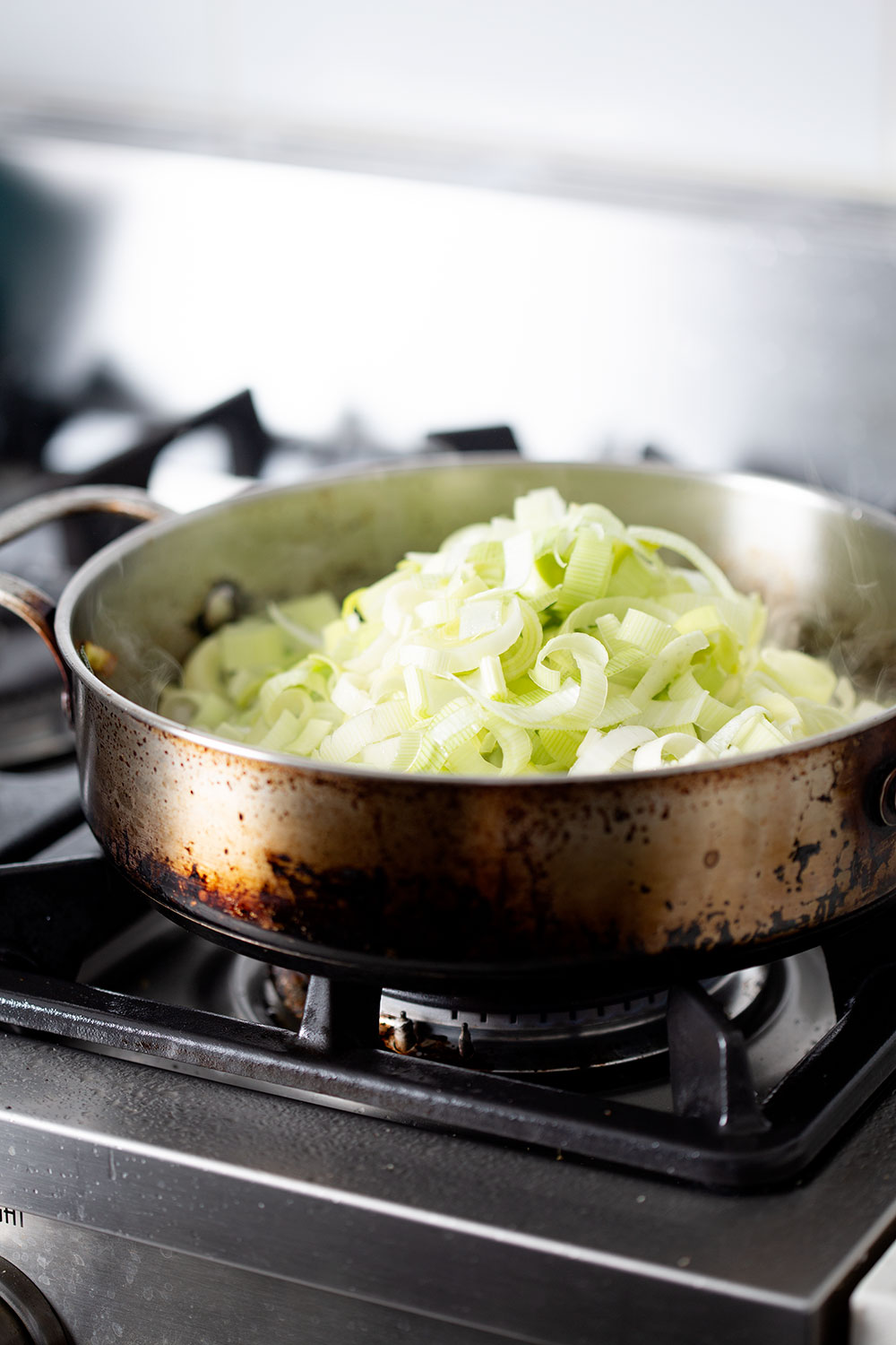 cooking leeks in pan on stove top