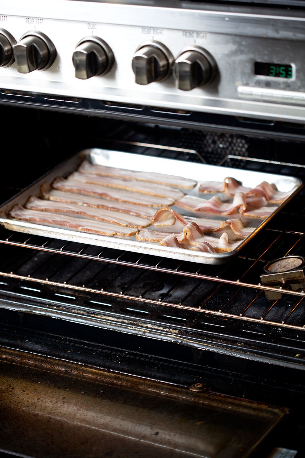 baking sheet of bacon in oven