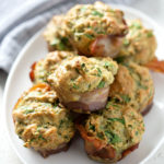 platter of spinach muffins on white background