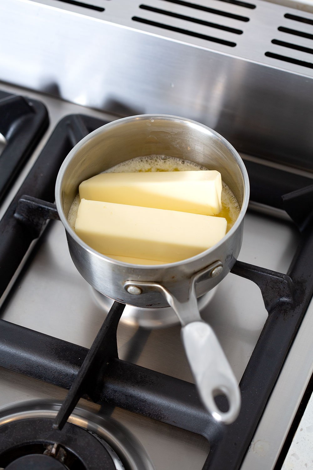 small saucepan filled with sticks of butter